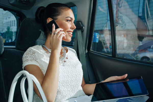 Woman Talking on Phone in Towncar Service